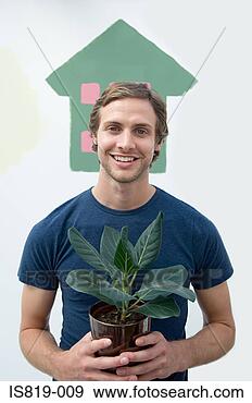 Stock Photograph - man holding a 
house plant. fotosearch 
- search stock 
photos, pictures, 
images, and photo 
clipart