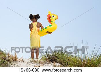 Stock Photography - girl holding inflatable 
ring. fotosearch 
- search stock 
photos, pictures, 
images, and photo 
clipart