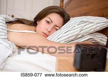 Picture - woman lying in 
bed. fotosearch 
- search stock 
photos, pictures, 
images, and photo 
clipart