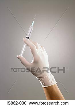 Stock Photography - person holding 
syringe. fotosearch 
- search stock 
photos, pictures, 
images, and photo 
clipart