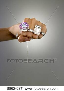 Picture - woman wearing 
rings on her fingers. 
fotosearch - search 
stock photos, 
pictures, images, 
and photo clipart