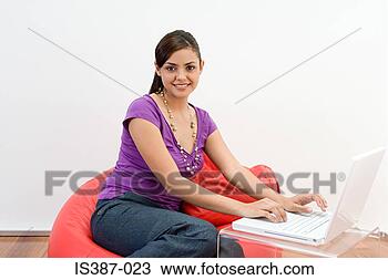 Stock Photo - female office 
worker sitting 
on a beanbag. 
fotosearch - search 
stock photos, 
pictures, images, 
and photo clipart