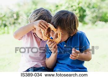 Stock Photo - two boys sharing 
a cake. fotosearch 
- search stock 
photos, pictures, 
images, and photo 
clipart