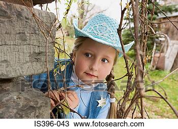 Stock Photo - cowgirl peering 
round corner. 
fotosearch - search 
stock photos, 
pictures, images, 
and photo clipart