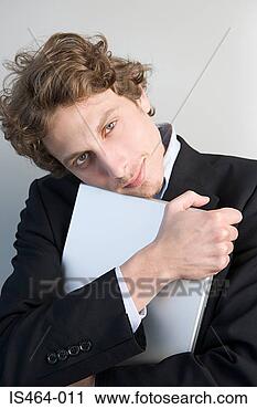 Arquivo de Fotografia - homem,  segurando, 
 laptop. fotosearch 
- busca de fotos, 
imagens e clipart
