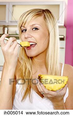 Stock Photo - woman eating pineapple. 
fotosearch - search 
stock photos, 
pictures, images, 
and photo clipart