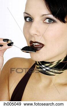 Stock Photograph - woman eating a 
spoonful of caviar. 
fotosearch - search 
stock photos, 
pictures, images, 
and photo clipart