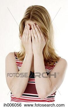 Stock Photo - woman covering 
her face with 
her hands. fotosearch 
- search stock 
photos, pictures, 
images, and photo 
clipart
