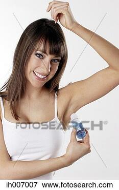 Picture - woman applying 
deodorant on her 
underarm. fotosearch 
- search stock 
photos, pictures, 
images, and photo 
clipart