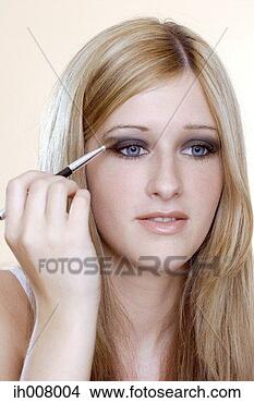 Stock Photo - woman applying 
eye shadow. fotosearch 
- search stock 
photos, pictures, 
images, and photo 
clipart