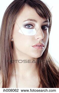 Stock Photo - woman doing under-eye 
treatment. fotosearch 
- search stock 
photos, pictures, 
images, and photo 
clipart