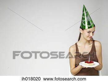 Stock Photography - girl with party 
hat holding a 
birthday cake. 
fotosearch - search 
stock photos, 
pictures, images, 
and photo clipart