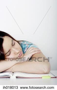 Stock Photo - girl sleeping 
on the revision 
book. fotosearch 
- search stock 
photos, pictures, 
images, and photo 
clipart