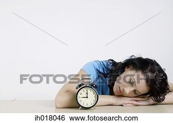 Stock Photo - woman sleeping 
beside an alarm 
clock. fotosearch 
- search stock 
photos, pictures, 
images, and photo 
clipart