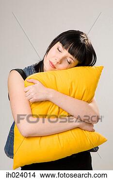 Stock Photo - woman hugging 
cushion with eyes 
closed. fotosearch 
- search stock 
photos, pictures, 
images, and photo 
clipart