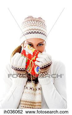 Stock Photo - woman in winter 
clothing holding 
a gift. fotosearch 
- search stock 
photos, pictures, 
images, and photo 
clipart