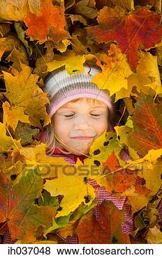 Stock Photo - girl with autumn 
leaves covering 
her. fotosearch 
- search stock 
photos, pictures, 
images, and photo 
clipart