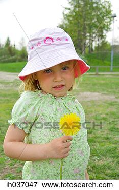 Picture - girl with hat 
holding a flower. 
fotosearch - search 
stock photos, 
pictures, images, 
and photo clipart