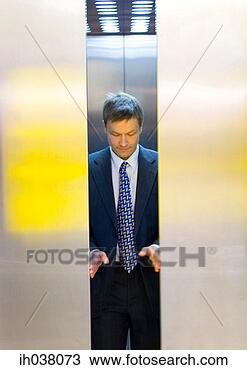 Stock Photo - businessman opening 
the elevator doors. 
fotosearch - search 
stock photos, 
pictures, images, 
and photo clipart