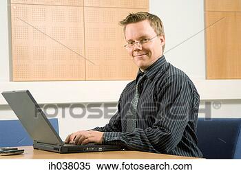 Stock Image - businessman working 
on his laptop. 
fotosearch - search 
stock photos, 
pictures, images, 
and photo clipart
