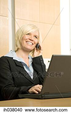 Stock Photography - businesswoman 
working on her 
laptop while talking 
on the mobile. 
fotosearch - search 
stock photos, 
pictures, images, 
and photo clipart