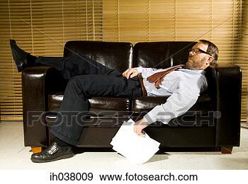 Stock Photograph - exhausted businessman 
sleeping on the 
couch. fotosearch 
- search stock 
photos, pictures, 
images, and photo 
clipart