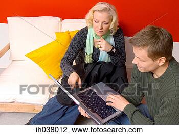 Stock Photo - man and woman 
using laptop together. 
fotosearch - search 
stock photos, 
pictures, images, 
and photo clipart