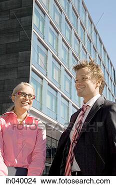 Stock Photo - businessman and 
businesswoman 
smiling. fotosearch 
- search stock 
photos, pictures, 
images, and photo 
clipart
