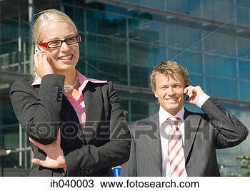 Stock Photo - businessman and 
businesswoman 
talking on the 
mobile phone. 
fotosearch - search 
stock photos, 
pictures, images, 
and photo clipart