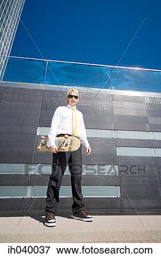 Picture - businessman posing 
with skateboard. 
fotosearch - search 
stock photos, 
pictures, images, 
and photo clipart