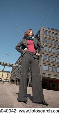 Stock Photo - businesswoman 
standing with 
arms akimbo. fotosearch 
- search stock 
photos, pictures, 
images, and photo 
clipart