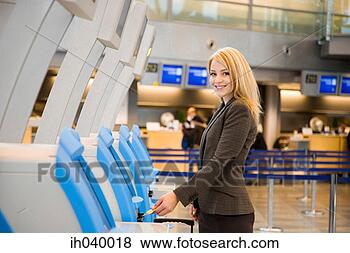 Stock Photo - businesswoman 
using an automated 
check-in machine. 
fotosearch - search 
stock photos, 
pictures, images, 
and photo clipart