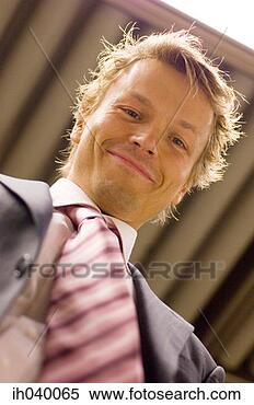 Stock Image - low angle view 
of happy businessman. 
fotosearch - search 
stock photos, 
pictures, images, 
and photo clipart