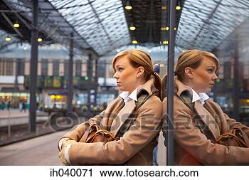Stock Photography - woman waiting 
for the train 
at the railway 
station. fotosearch 
- search stock 
photos, pictures, 
images, and photo 
clipart