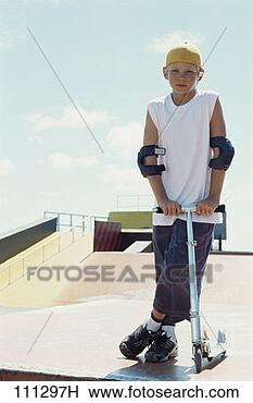Stock Photo - portrait of a 
preteen and his 
scooter at the 
skate park. fotosearch 
- search stock 
photos, pictures, 
images, and photo 
clipart