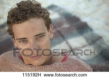 Stock Photo - portrait of a 
man lounging on 
a beach blanket. 
fotosearch - search 
stock photos, 
pictures, images, 
and photo clipart