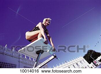 Stock Photo - female, block, 
elderly, diving, 
blue, lady, active. 
fotosearch - search 
stock photos, 
pictures, images, 
and photo clipart