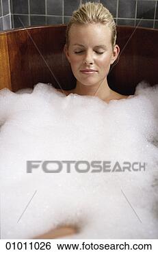Stock Photo - a content looking 
woman relaxing 
in a hot tub. 
fotosearch - search 
stock photos, 
pictures, images, 
and photo clipart