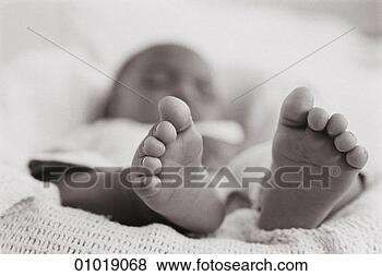 Stock Photo - a baby asleep 
in a cot with 
the focus on its 
feet, sepia. fotosearch 
- search stock 
photos, pictures, 
images, and photo 
clipart