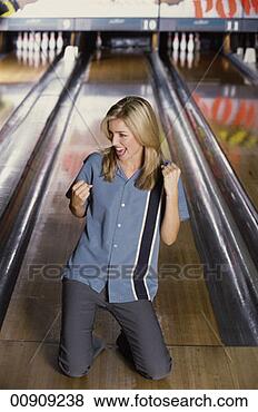 Stock Photo - a young woman 
celebrating at 
a bowling alley. 
fotosearch - search 
stock photos, 
pictures, images, 
and photo clipart