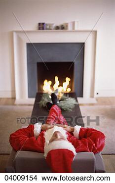 Stock Photo - man dressed up 
as father christmas 
asleep in front 
of the fire. fotosearch 
- search stock 
photos, pictures, 
images, and photo 
clipart