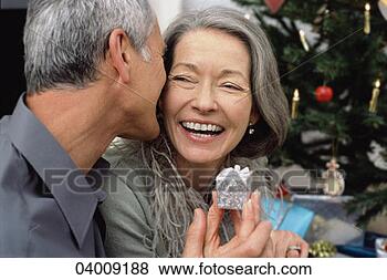 Stock Photo - mature couple 
at christmas time. 
fotosearch - search 
stock photos, 
pictures, images, 
and photo clipart