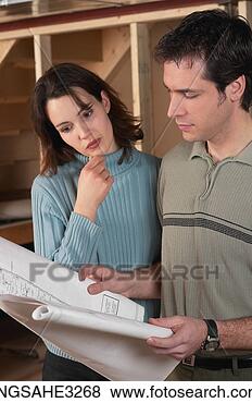 Stock Photo - adult couple looking 
at blue prints 
in house under 
construction. 
fotosearch - search 
stock photos, 
pictures, images, 
and photo clipart