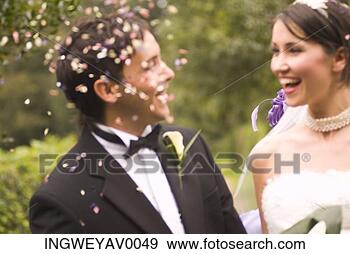 Stock Photograph - close-up of a 
young bride and 
groom under falling 
confetti. fotosearch 
- search stock 
photos, pictures, 
images, and photo 
clipart