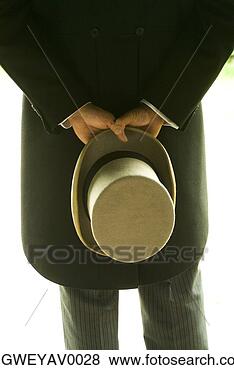 Stock Photo - rear view of a 
man holding a 
hat behind his 
back. fotosearch 
- search stock 
photos, pictures, 
images, and photo 
clipart