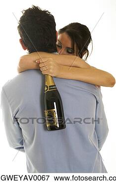 Picture - a young woman 
hugging a man 
with a champagne 
bottle in hand. 
fotosearch - search 
stock photos, 
pictures, images, 
and photo clipart