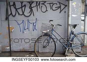 Stock Photo - vintage bicycle 
leaning against 
wall with graffiti. 
fotosearch - search 
stock photos, 
pictures, images, 
and photo clipart