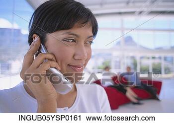 Stock Photography - close-up of a 
young woman talking 
on a mobile phone. 
fotosearch - search 
stock photos, 
pictures, images, 
and photo clipart