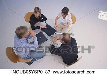 Picture - high angle view 
of four business 
executives in 
a meeting. fotosearch 
- search stock 
photos, pictures, 
images, and photo 
clipart