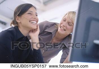 Picture - low angle view 
of two young woman 
laughing together. 
fotosearch - search 
stock photos, 
pictures, images, 
and photo clipart